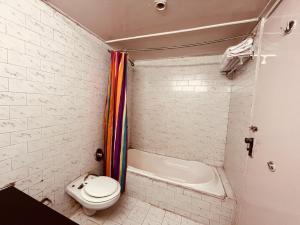 a small bathroom with a toilet and a shower at Sagar Resort Manali By Ramanand Sagar Ramayan Maker-#Near Mall Road # Big Parking # Mountain View in Manāli +8 photos
