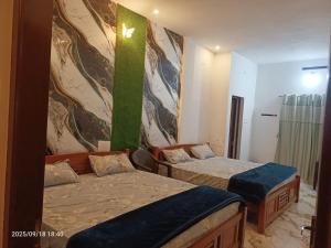 Ένα ή περισσότερα κρεβάτια σε δωμάτιο στο Wildlife Homestay