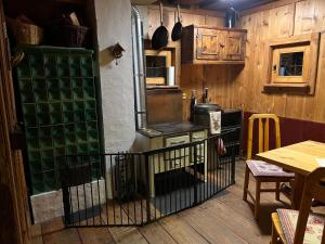a kitchen with an old stove and wooden walls at Almhütte Kärnten in Maltaberg +45 photos