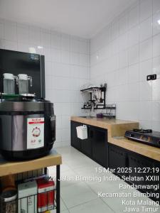 a kitchen with a coffee maker on a counter at Neomi Homestay Malang in Wendit +22 photos