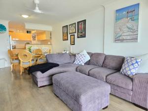 a living room with a couch and a table at Fairways Golf & Beach Retreat Bribie Island in Woorim