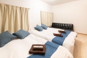 two beds sitting next to each other in a bedroom at 電車で秋葉原駅11分 東京駅18分 平井駅徒歩8分 in Tokyo