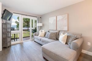 a living room with a couch and a tv at Lake Winni Condo - Beach, Concerts and Views for miles in Gilford