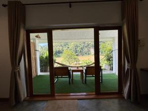 a dining room with a table and a large window at Amanda Riverside in Nongkhiaw