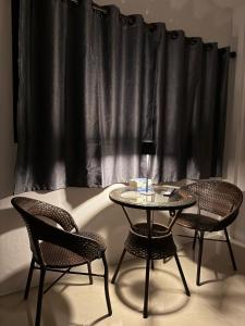 a table and two chairs in front of a window at Pakkan Hotel พักกาญจน์ in Kanchanaburi