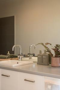 a kitchen counter with a sink and a mirror at The Slow Acre Myponga Beach Relax and Reconnect in nature in Myponga +55 photos