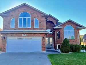 a large brick house with a large garage at Windsor Home Room 3 in Windsor