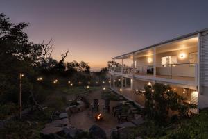 a house with a fire pit in a yard at night at The Slow Acre Myponga Beach Relax and Reconnect in nature in Myponga