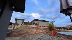 a house with a brick wall in front of it at LUZ DE LUNA mesa de los santos house in Los Santos