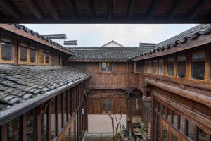 an old house with wooden walls and windows at Hangzhou Eight Blessings Inn-200 years old courtyard house in Tonglu