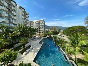 an overhead view of a swimming pool in a resort at By The Sea @ Luxury Suites, Batu Ferringhi in Batu Ferringhi