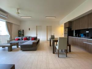 a living room with a couch and a table at By The Sea @ Luxury Suites, Batu Ferringhi in Batu Ferringhi