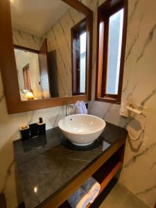 a bathroom with a sink and a mirror at 2 bedroom mesari bona in Blahbatu