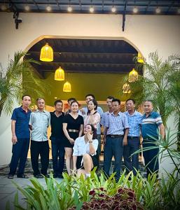 a group of people posing for a picture in front of a building at Sol Flow Retreat in Nguyên Ngoại