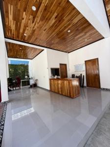a large room with a wooden ceiling and a table at Amanda Boutique in Nongkhiaw