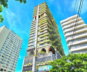 a tall apartment building with plants on it at The Signature Hotel Nha Trang in Nha Trang
