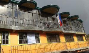a yellow building with a balcony on top of it at Mountain Pine Breeze in Sampong