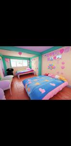 a bedroom with two beds with hearts on the wall at Mountain Pine Breeze in Sampong