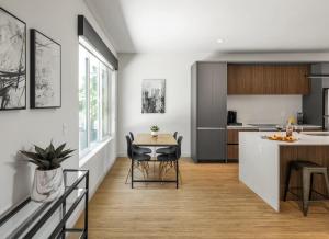 a kitchen and living room with a table and a counter at Chaparral - 2 Units - Jacuzzi - Heart of Old Town in Scottsdale