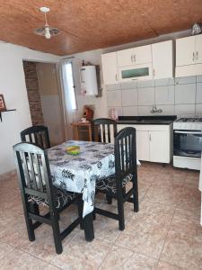 Una cocina con una mesa y sillas en una habitación. en Camping El Chañar, en Jocolí Viejo