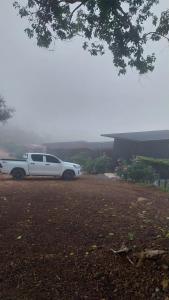 a white limousine parked in a parking lot at ไร่ปราณปรียา in Campson