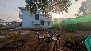 a group of chairs in front of a building at One World Luxury Villas in Korlai