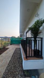 a house with a palm tree on a balcony at One World Luxury Villas in Korlai