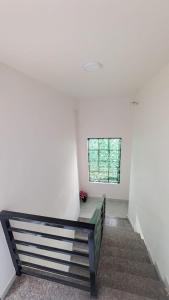 a staircase with a bench in a room with a window at One World Luxury Villas in Korlai