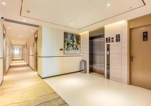 a hallway of an office building with a painting on the wall at City Comfort Inn Quanzhou Wanda in Quanzhou