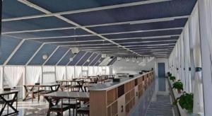 a dining room with tables and chairs and blue ceilings at GreenTree Inn Express Liaoning Jinzhou Bijia Mountain in Dandong +35 photos