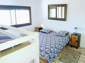 a bedroom with a bed with pillows on it at Maison Plage Mer in Cargèse
