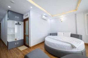 a bedroom with a large white bed in a room at The Land Hotel & Apartment in Vung Tau