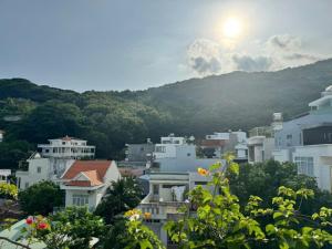 a view of a city with mountains in the background at The Land Hotel & Apartment in Vung Tau