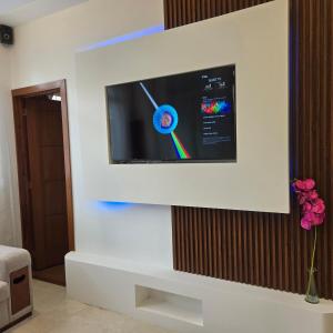 a television on a wall in a living room at majesty beautiful suite in Cuenca