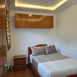 a bedroom with a bed and wooden cabinets at majesty beautiful suite in Cuenca