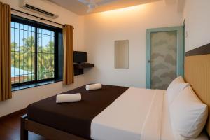 En eller flere senge i et værelse på Grantley - Alibag Beach