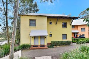 a yellow house with a white roof at Villa 2br Pinot Nois Villa in Pokolbin