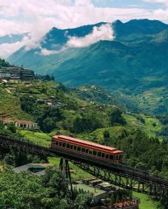 a train on a bridge over a mountain at Sapa Symphony Hotel in Sa Pa