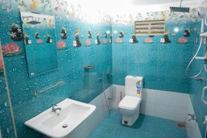 a blue bathroom with a sink and a toilet at Mango House River Inn Negombo in Kochchikade +43 photos