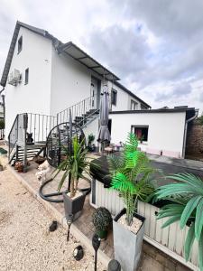 a house with plants in front of it at Csobogó Suites Apartman in Keszthely