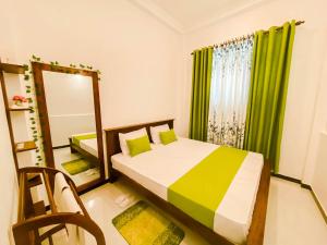 a bedroom with a bed and a mirror and a window at Hidden Pearl in Kandy