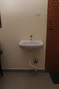a white sink in a wall with a pipe at Magesh Residency in Jāmb