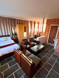 a hotel room with a bed and a living room at Deepjyoti Inn in Pashupatināth