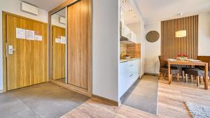 a kitchen and a dining room with a table at Apartament Góry i Las in Szklarska Poręba