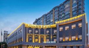 a large building with a sign on top of it at Lavande Hotel Changchun Gaoxin Jilin University in Changchun