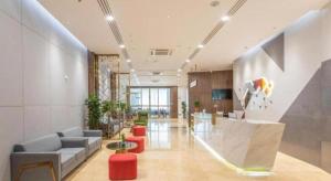 a lobby with a couch and chairs and a table at Borrman Hotel Guilin Railway Station Two Rivers and Four Lakes in Guilin