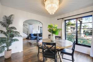 un comedor con mesa, sillas y una planta en West Beach Villa 4, en Santa Bárbara