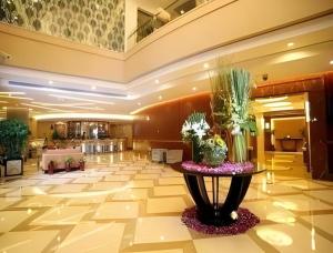 a lobby with a table with plants on it at Ramada by Wyndham Wujiaochang Shanghai in Shanghai