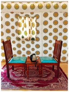 a room with two chairs and a table with a telephone at Solo Travel Desert Safari Camp in Jaisalmer +50 photos