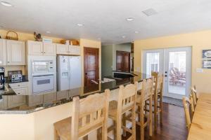 a kitchen with white appliances and a table and chairs at Lone Eagle Haven home in Mesa